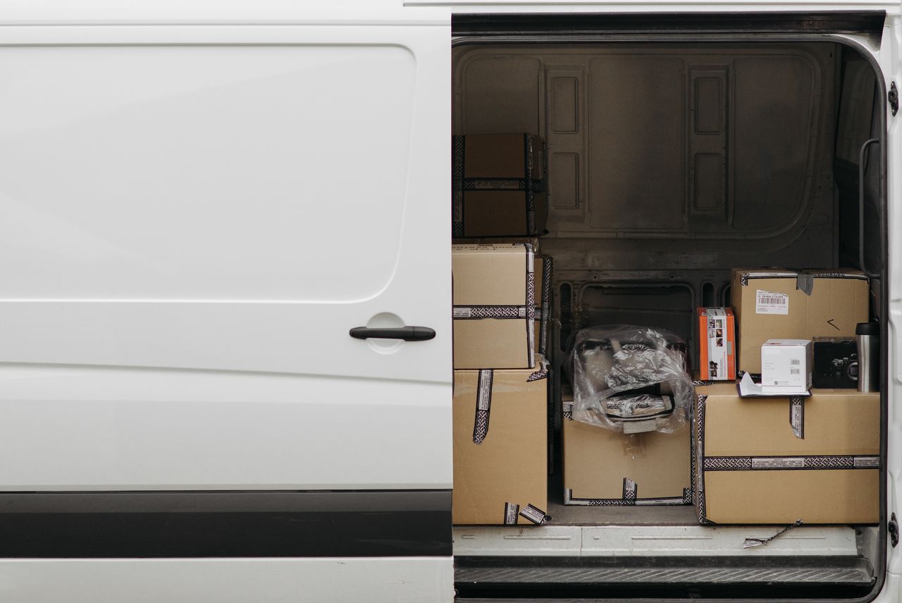 Home Open delivery van filled with boxes, ready for logistics and transport services.